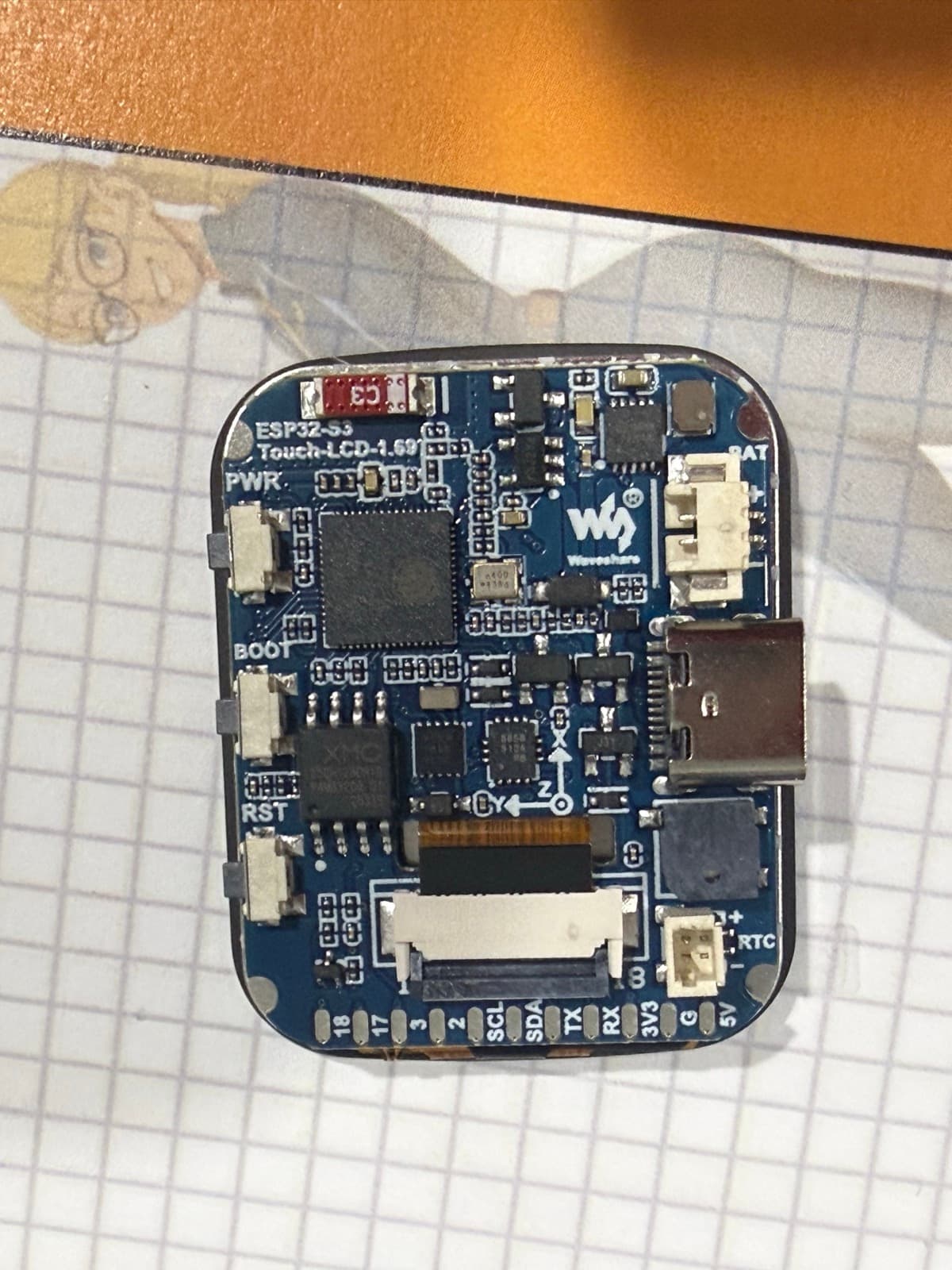 The physical Waveshare ESP32-S3 Touch-LCD-1.69 board, showing its printed board identity and USB-C connector.
