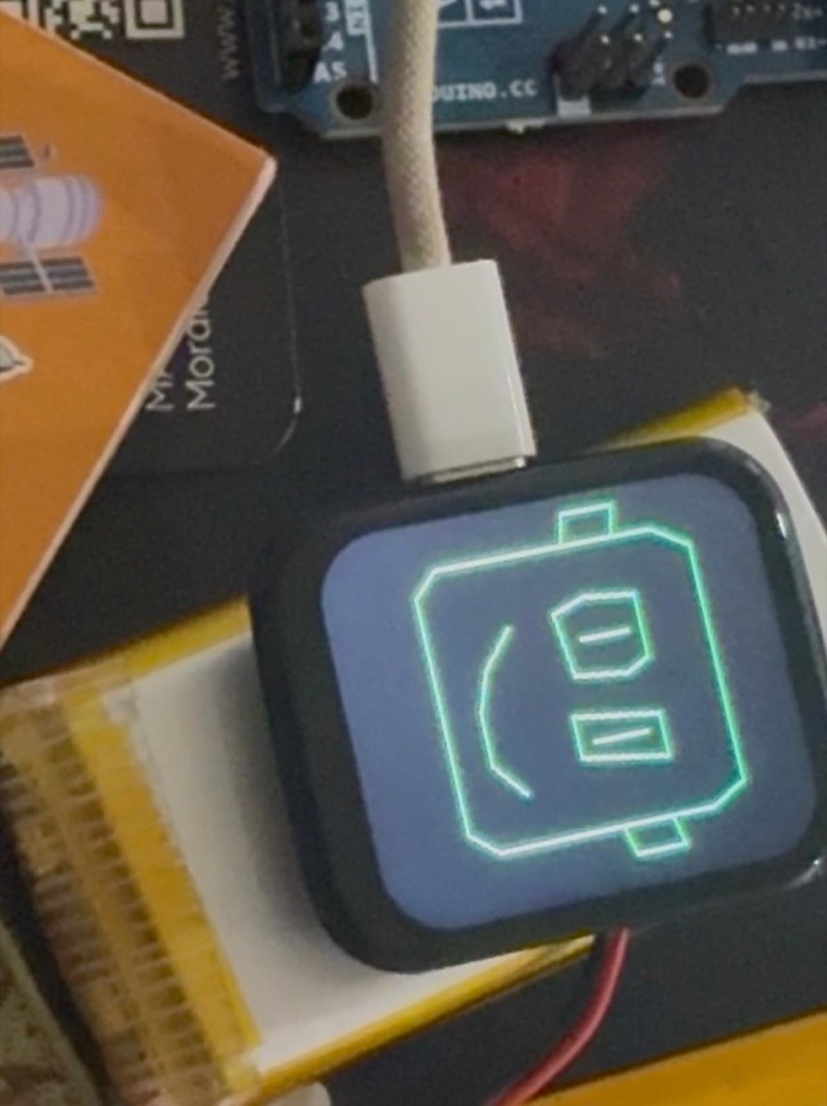 A USB-powered MaxBot display rendering a turquoise icon expression.
